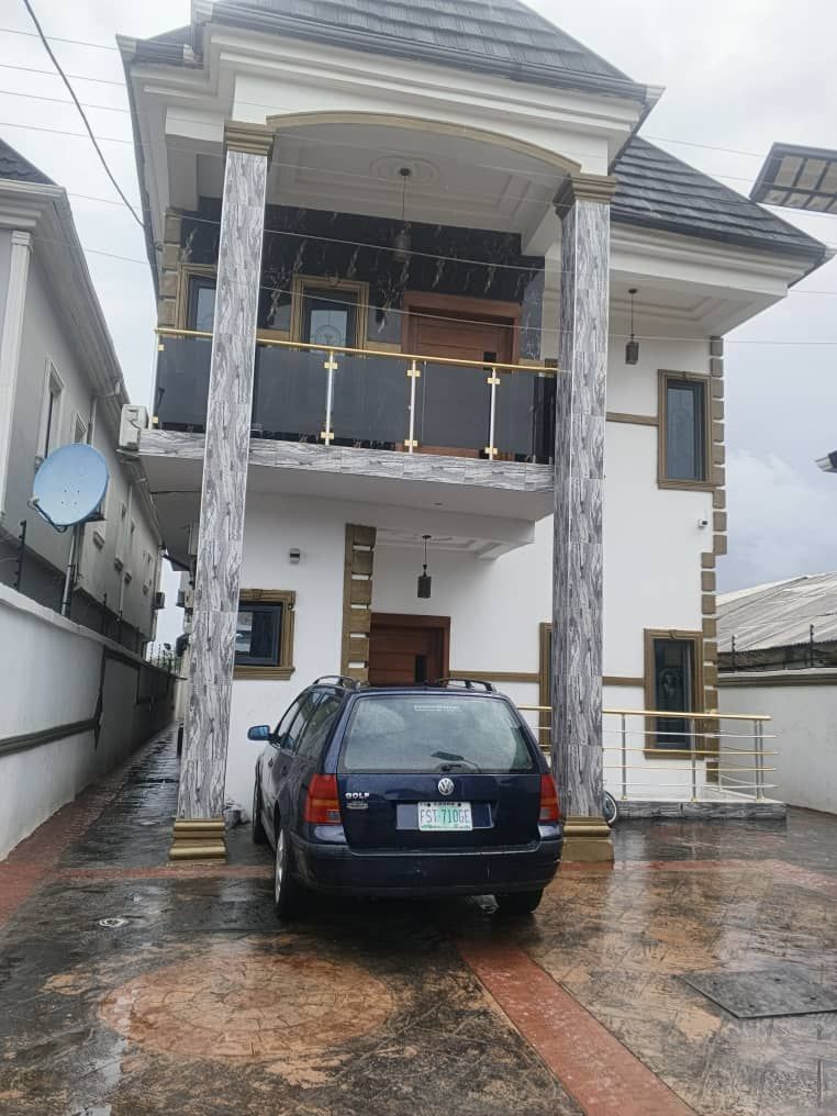 White duplex with a car in the driveway