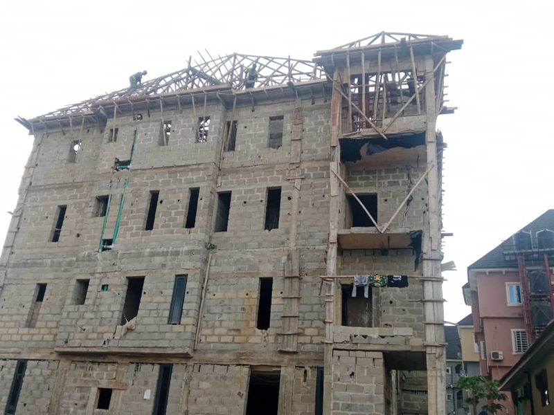Multi-storey block building with roof framing in progress