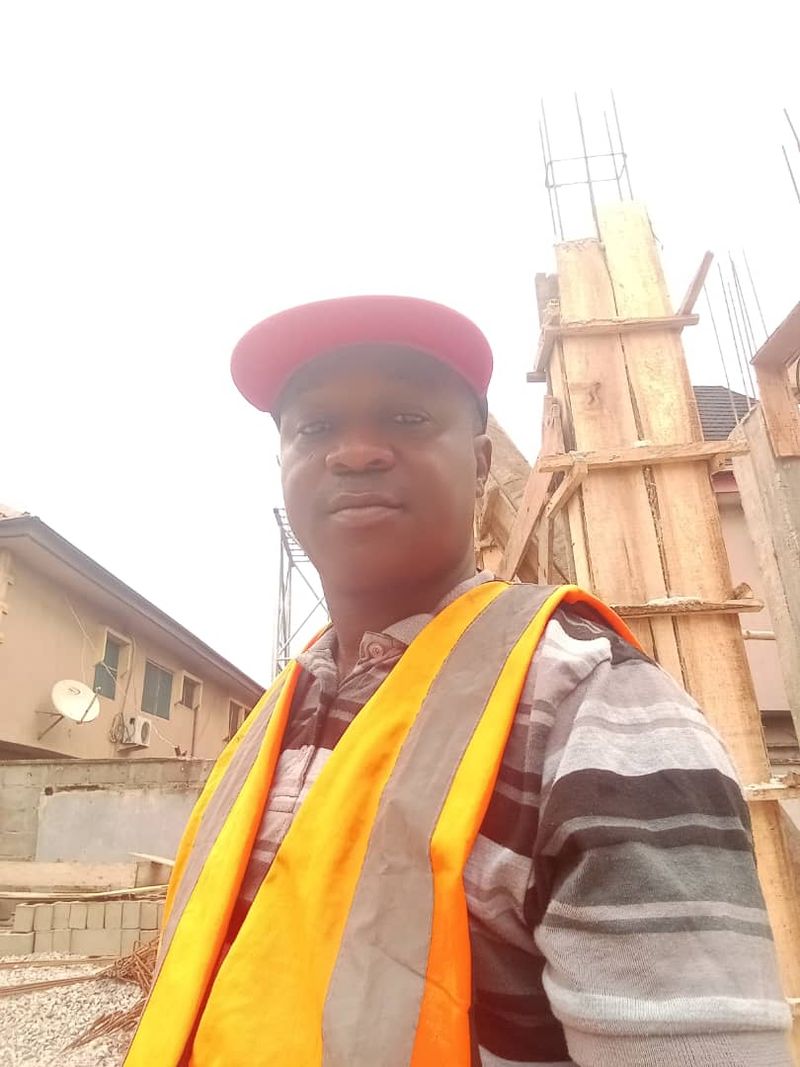 Team member in a safety vest beside column formwork